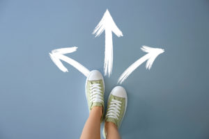 Woman,Standing,On,Color,Background,With,Arrows,Pointing,In,Different Woman,Standing,On,Color,Background,With,Arrows,Pointing,In,Different